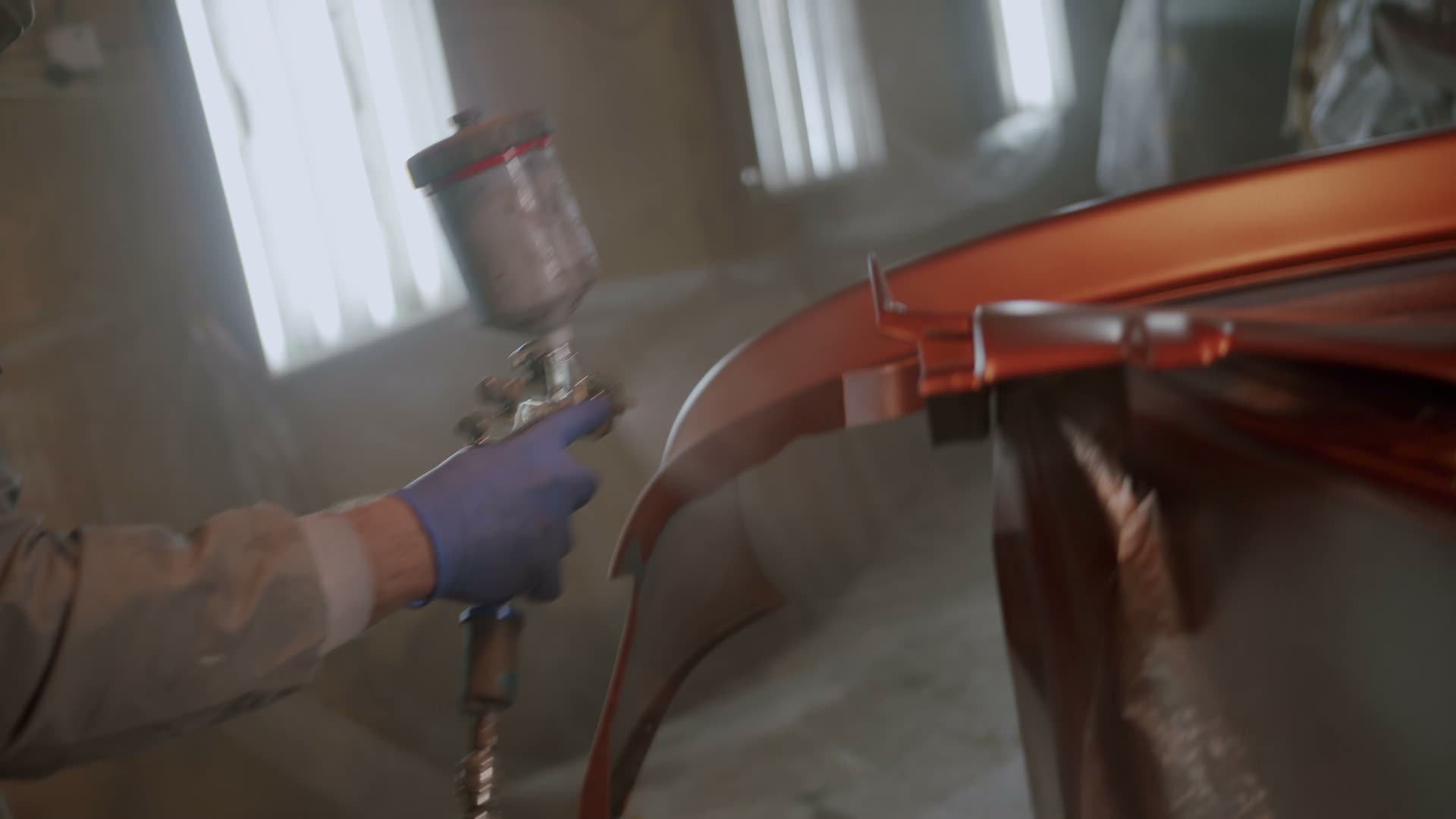 Group II auto body shop — cars in paint booth, repair work in progress